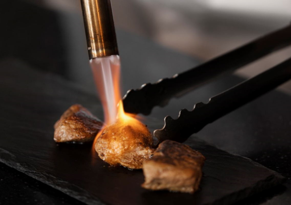 A tiny laptop in the palm of a hand